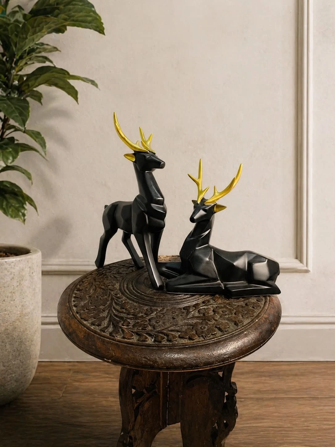 Sculptural deer with gold-toned antlers, styled in a warm living space